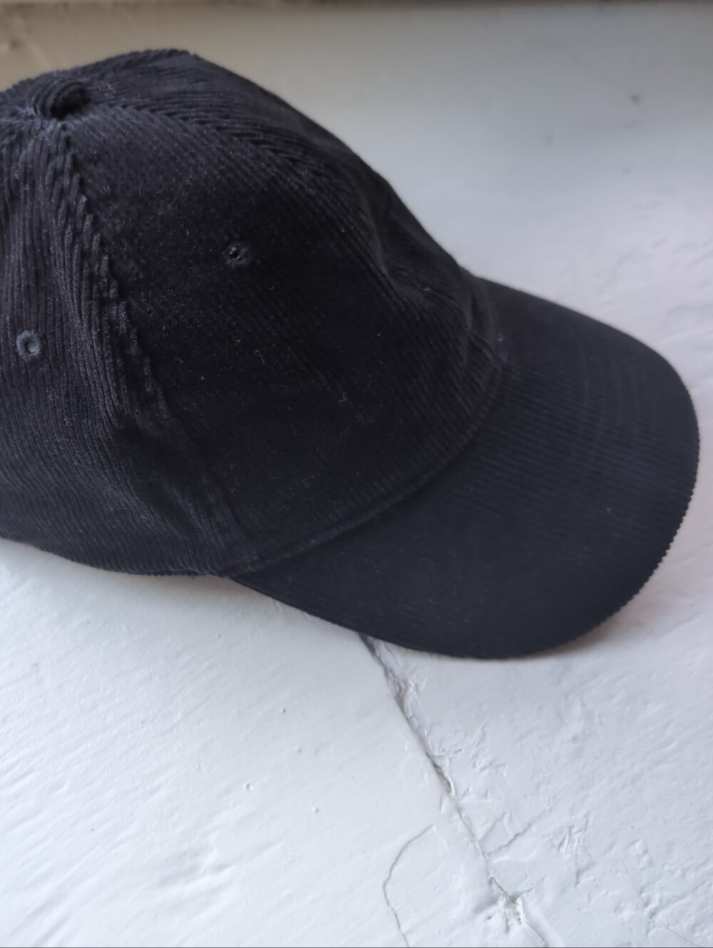 Black corduroy baseball cap with adjustable strap